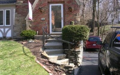 House entrance with steps and railing.